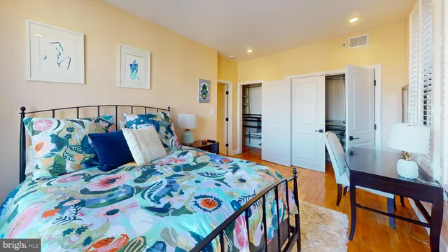 a bedroom with a bed and a dresser