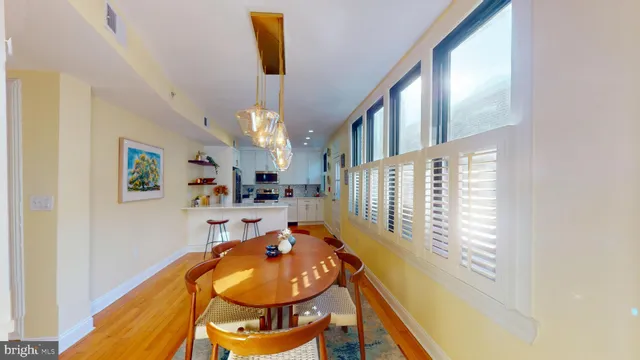 a view of a dining room with furniture and a chandelier
