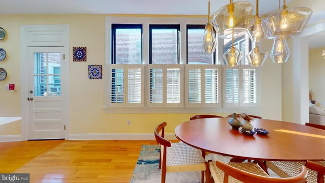 a view of a dining room with furniture and chandelier