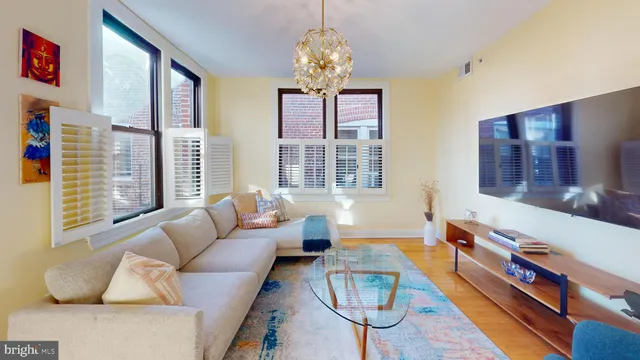 a living room with furniture and a chandelier