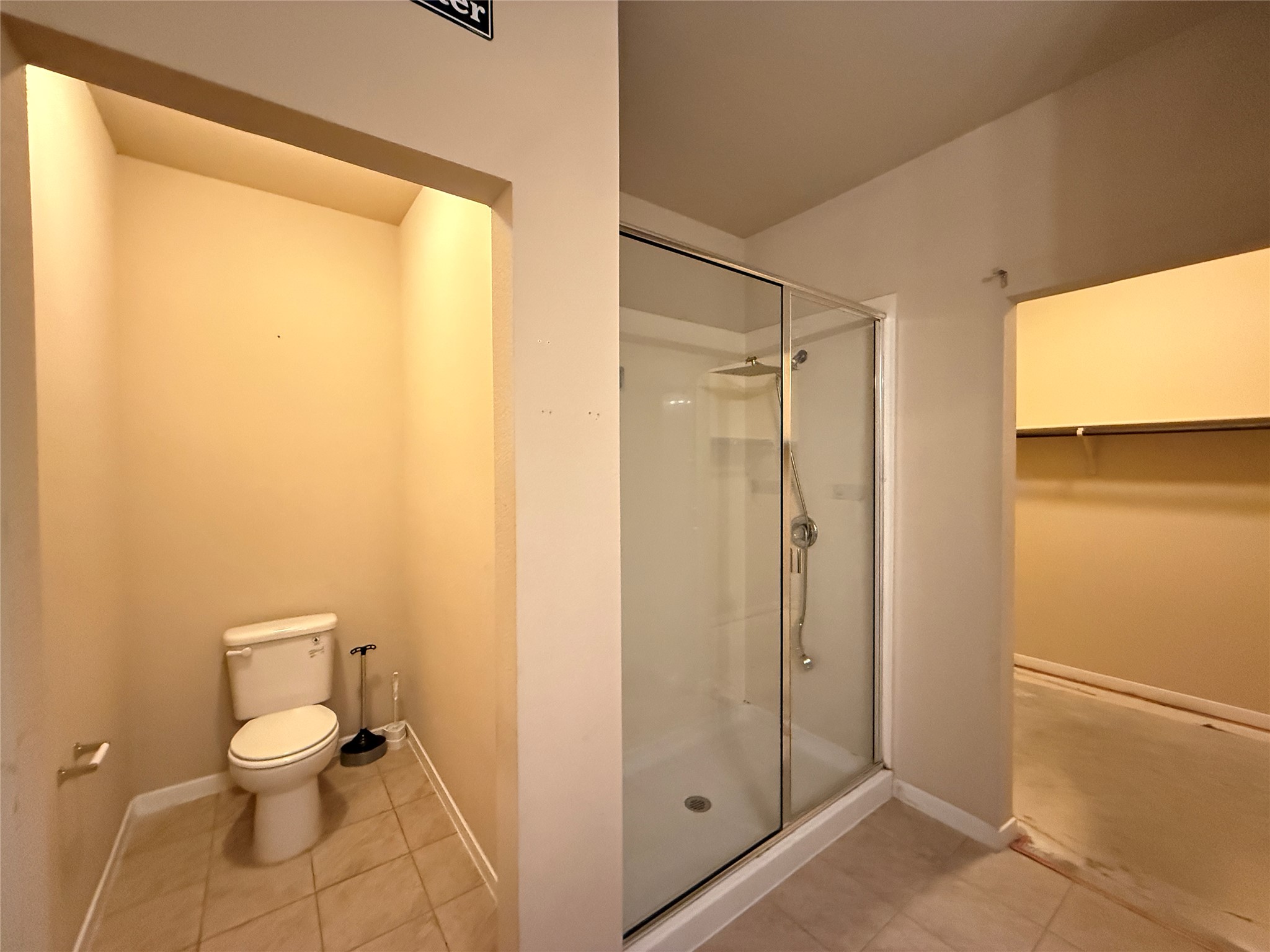 1602 Atlantica Street Cedar Park, TX 78613 - Photo 12 of 24 Bathroom with a shower stall, a walk in closet, and light tile patterned floors