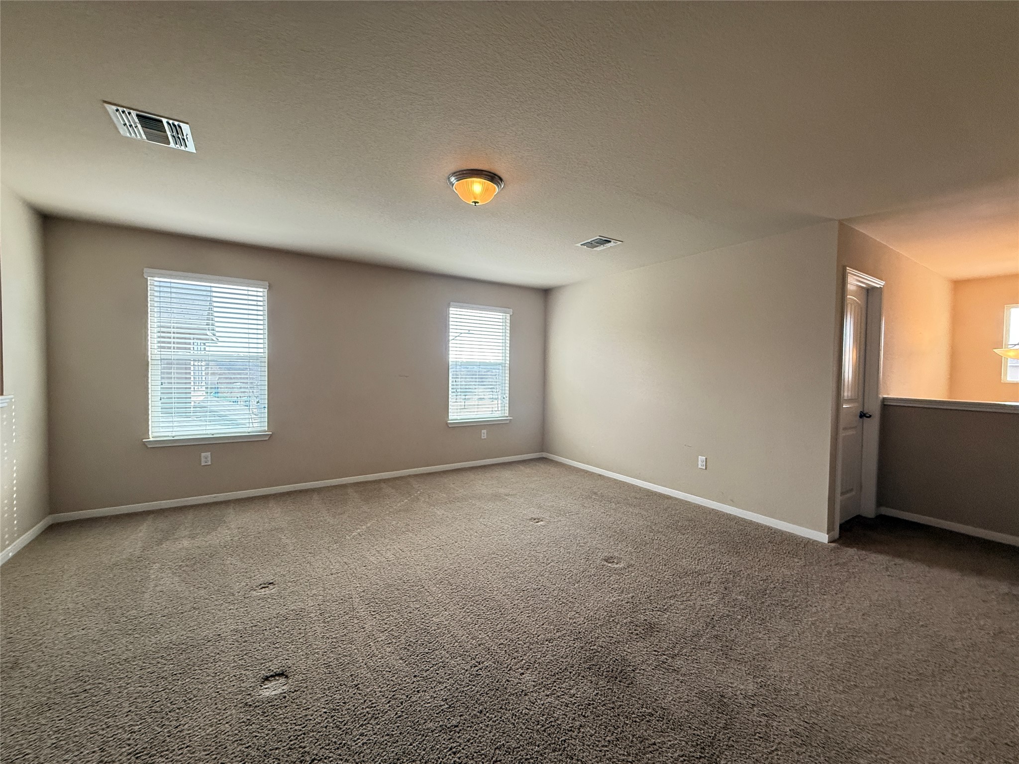 1602 Atlantica Street Cedar Park, TX 78613 - Photo 15 of 24 Spare room with carpet flooring and a textured ceiling