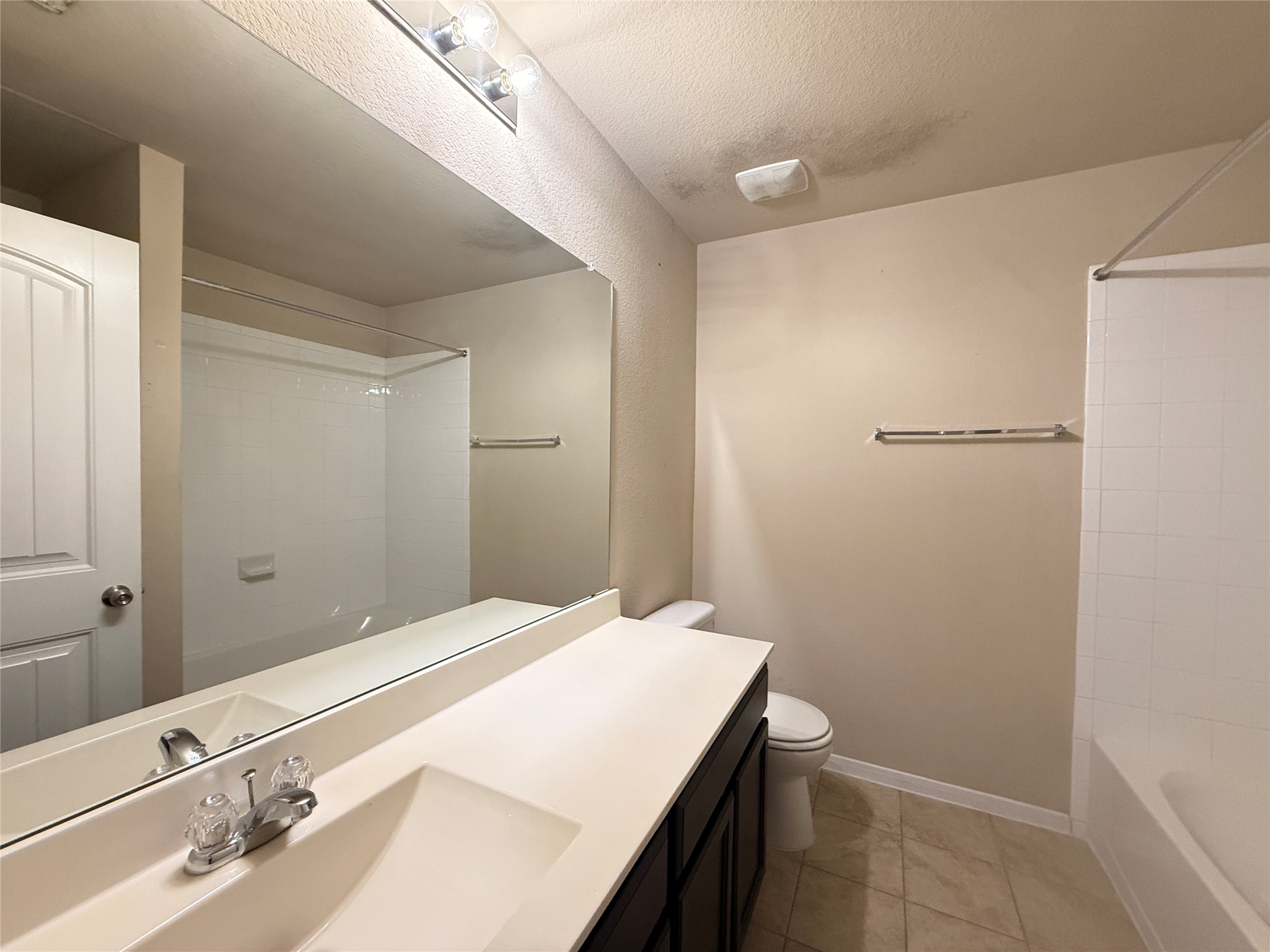 1602 Atlantica Street Cedar Park, TX 78613 - Photo 18 of 24 Full bath with shower / washtub combination, vanity, light tile patterned flooring, and a textured ceiling