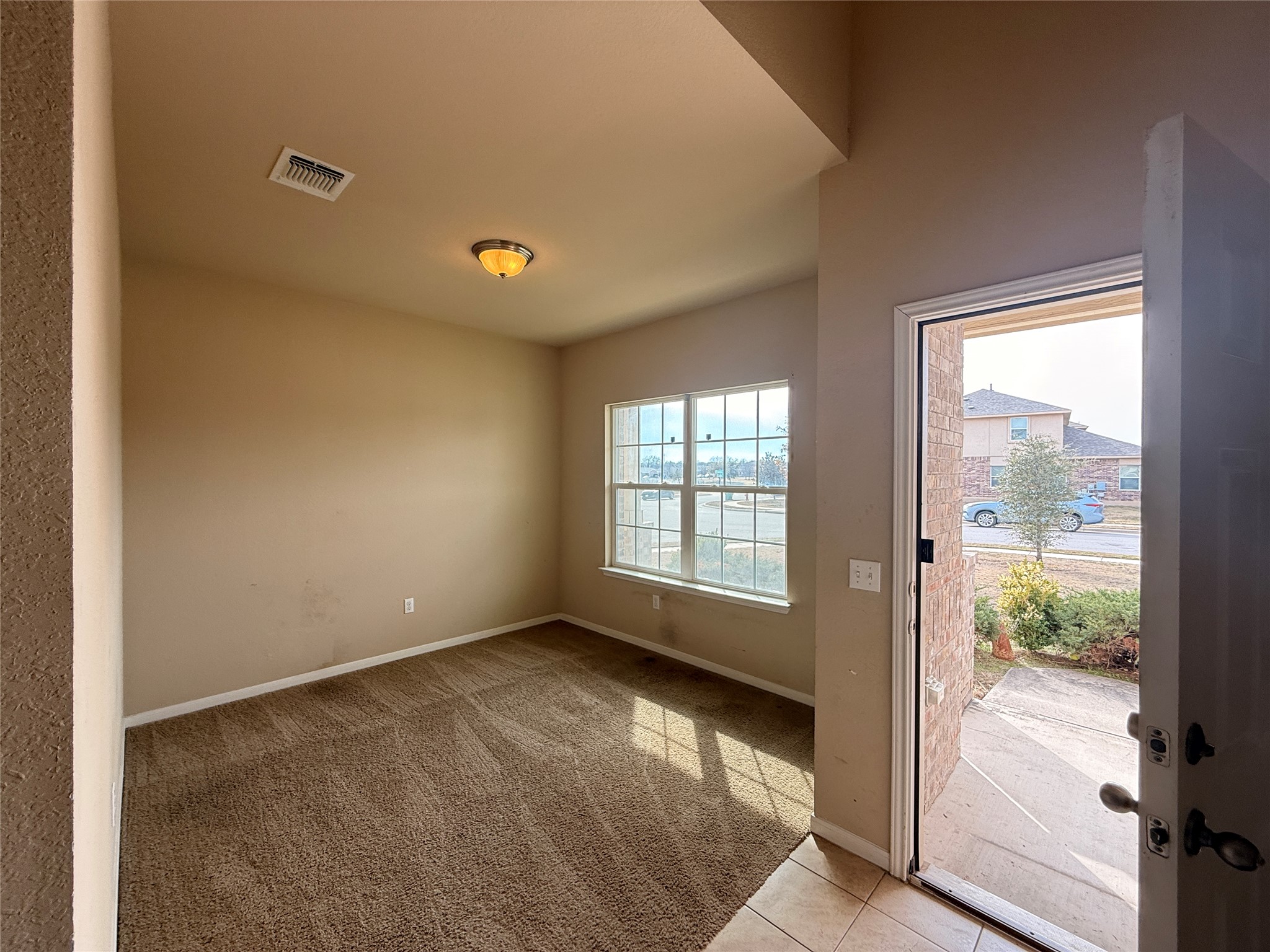 1602 Atlantica Street Cedar Park, TX 78613 - Photo 4 of 24 Entryway with carpet floors and tile patterned flooring