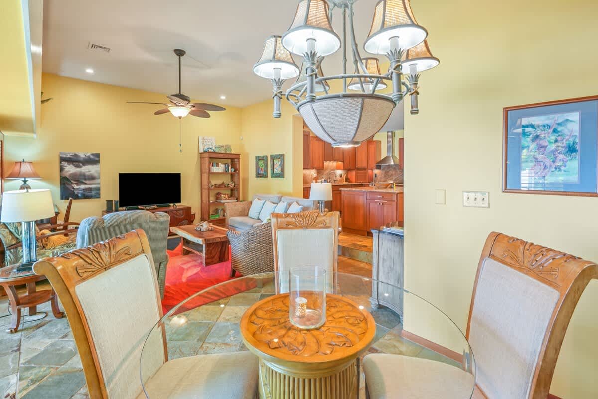 366 Papaloa Road, Unit 114 Kapaa, HI 96746 - Photo 19 of 23 a living room with furniture a chandelier and a flat screen tv