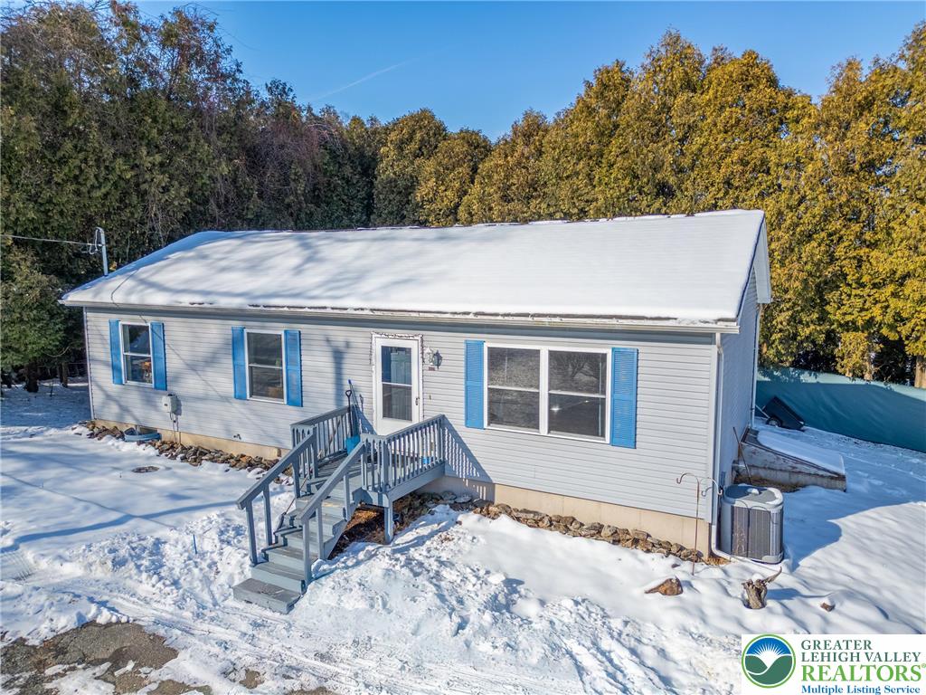 a view of a house with a yard and sitting area