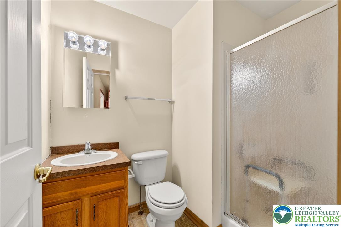 4859 Vera Cruz Road Emmaus, PA 18049 - Photo 14 of 23 a bathroom with a toilet sink and mirror