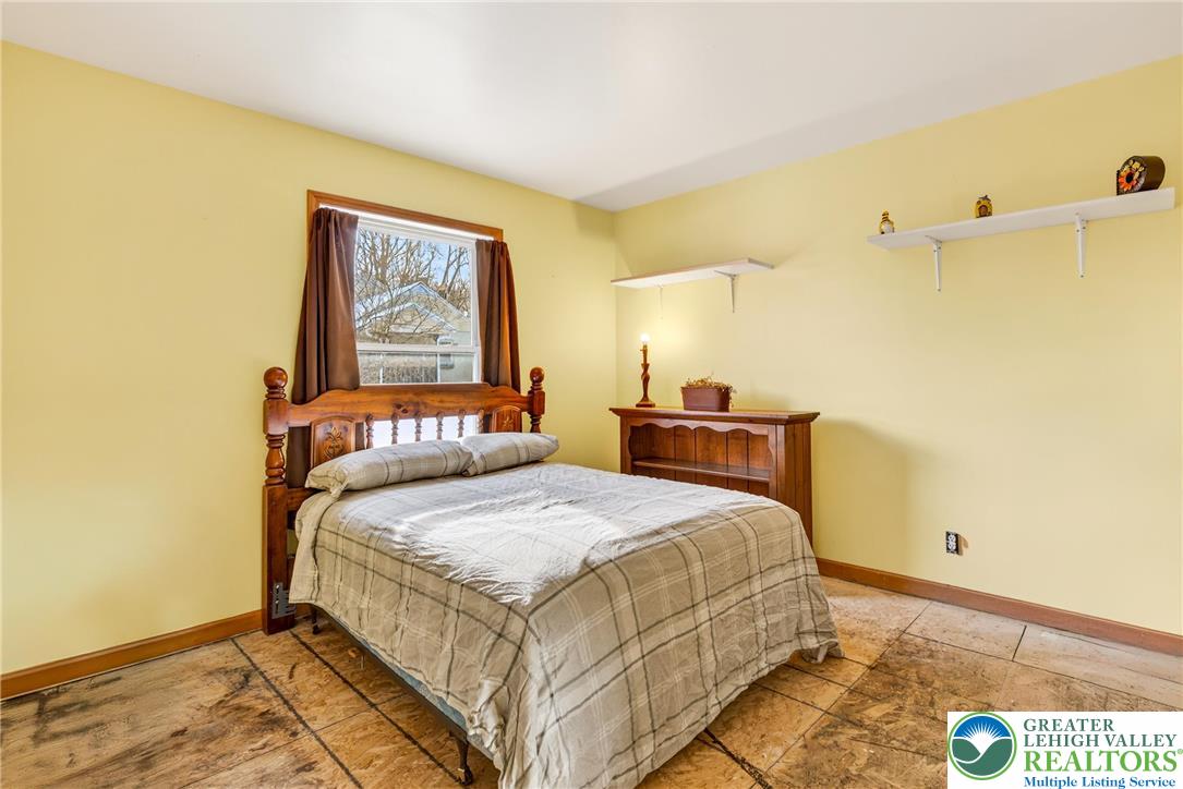 4859 Vera Cruz Road Emmaus, PA 18049 - Photo 15 of 23 a bedroom with a bed and a painting on the wall