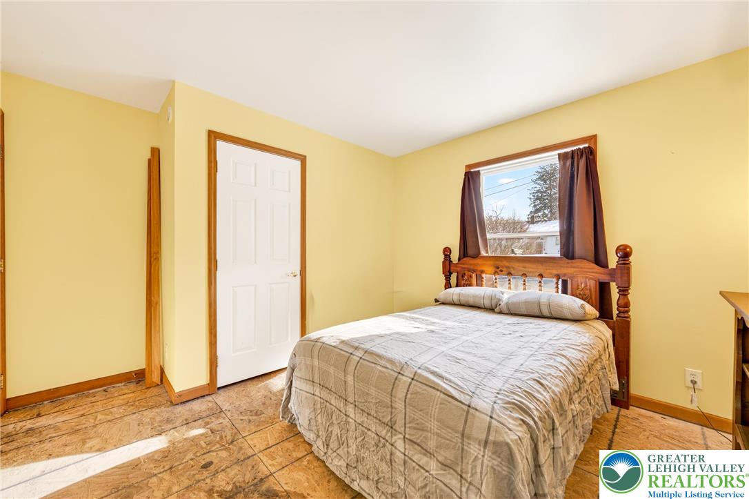 4859 Vera Cruz Road Emmaus, PA 18049 - Photo 16 of 23 a bedroom with a bed and a painting on the wall