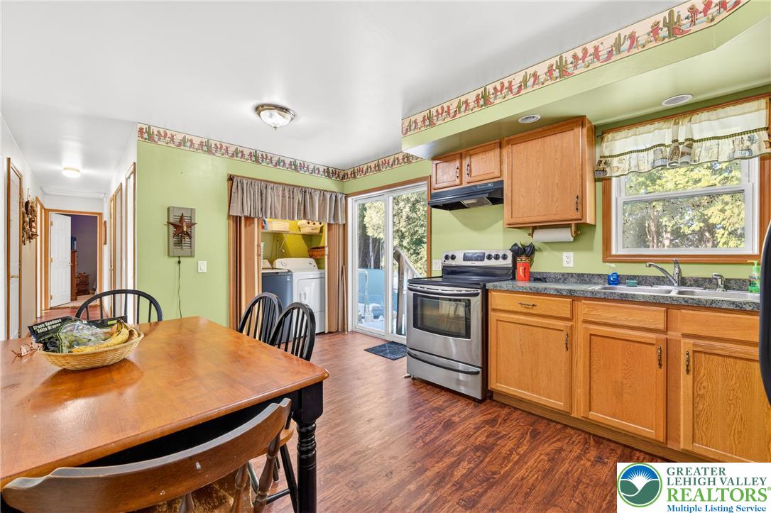 4859 Vera Cruz Road Emmaus, PA 18049 - Photo 10 of 23 a kitchen with stainless steel appliances granite countertop a stove a sink dishwasher and a refrigerator with wooden floor