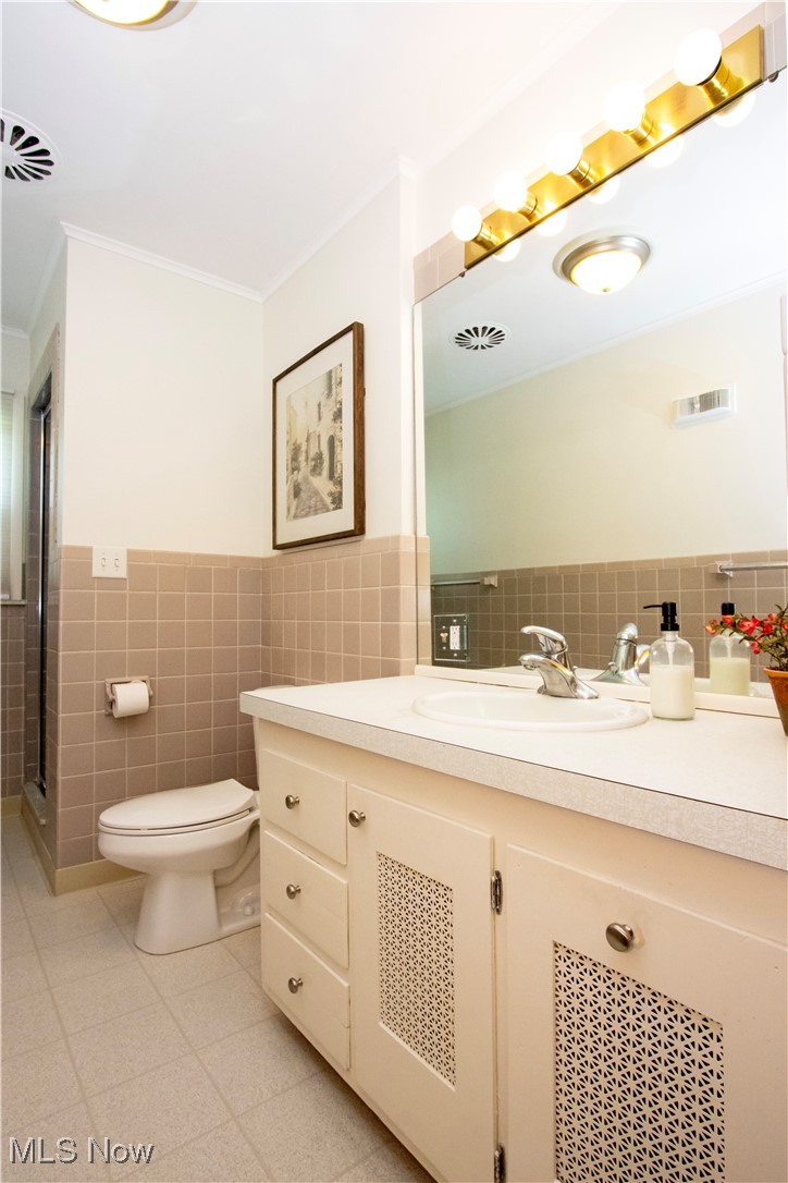 416 East Beverly Road Wooster, OH 44691 - Photo 30 of 36 Full bath with tile walls, vanity, toilet, ornamental molding, and a wainscoted wall