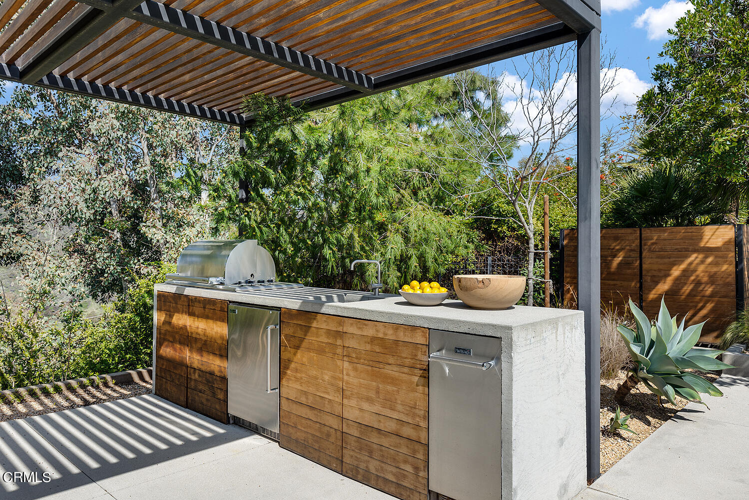 95 Tustin Road Pasadena, CA 91105 - Photo 36 of 41 a view of a patio with table and chairs with wooden floor and fence