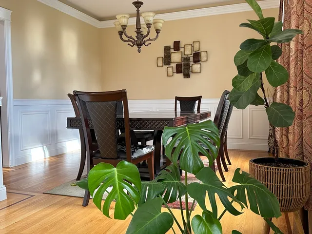 a view of a dining room with furniture wooden floor and chandelier