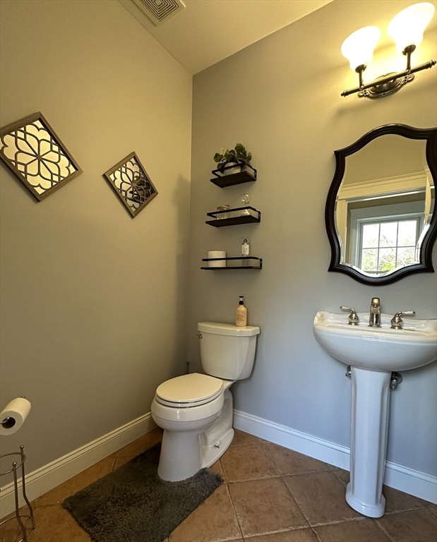7 Rising Corner Road Southwick, MA 01077 - Photo 16 of 42 a bathroom with a toilet sink and mirror