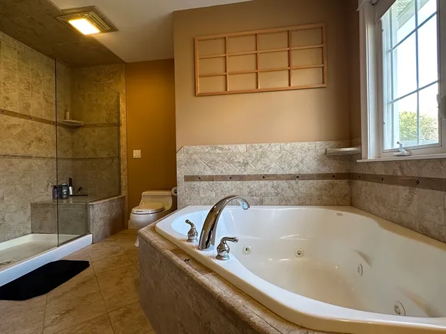 a bathroom with a bathtub and a shower