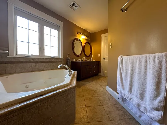 a spacious bathroom with a bathtub and a shower