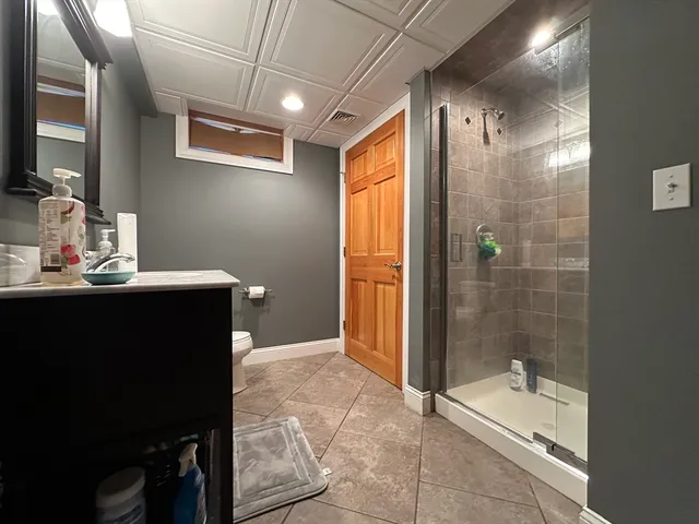 a bathroom with a tub a sink and a shower