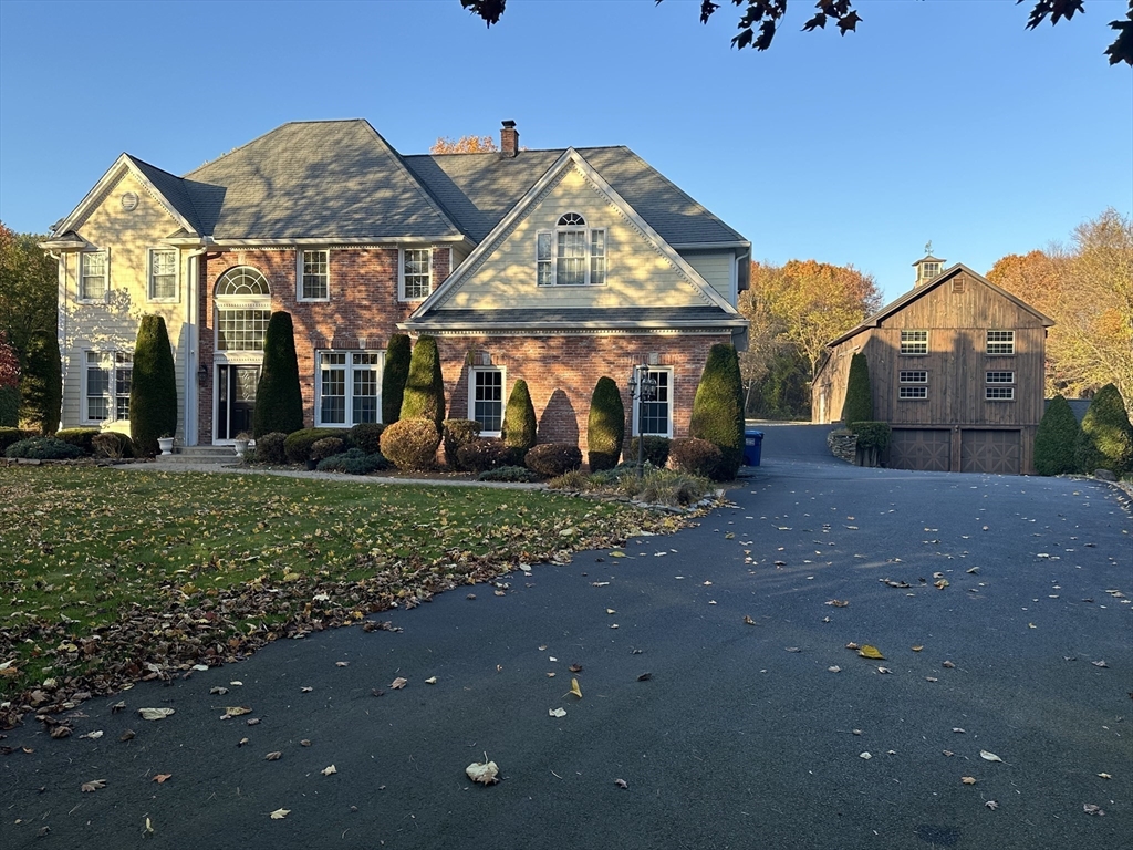 7 Rising Corner Road Southwick, MA 01077 - Photo 4 of 42 a view of a white house with a yard and potted plants