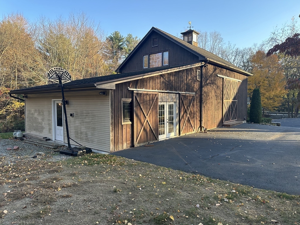 7 Rising Corner Road Southwick, MA 01077 - Photo 42 of 42 a view of a small house with wooden fence