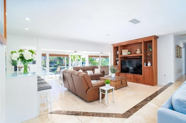 a kitchen with stainless steel appliances a stove a sink a refrigerator white cabinets and a refrigerator