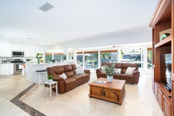 a kitchen with stainless steel appliances granite countertop a refrigerator stove microwave and sink