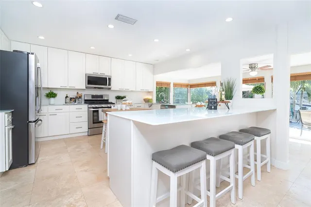 a bathroom with a granite countertop sink and a washing machine