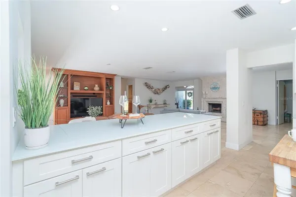 a bathroom with a granite countertop sink and a washing machine