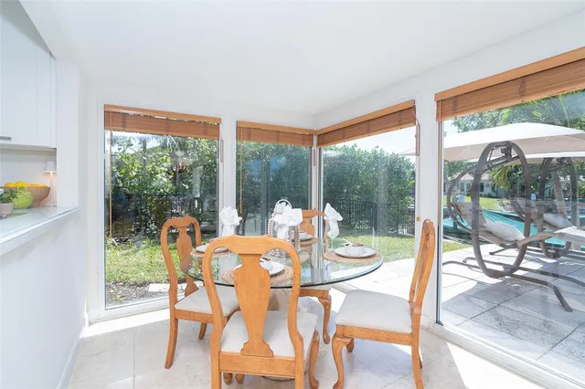 a view of a porch with furniture and a yard