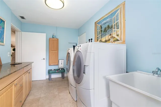 a view of a swimming pool with chair and tables