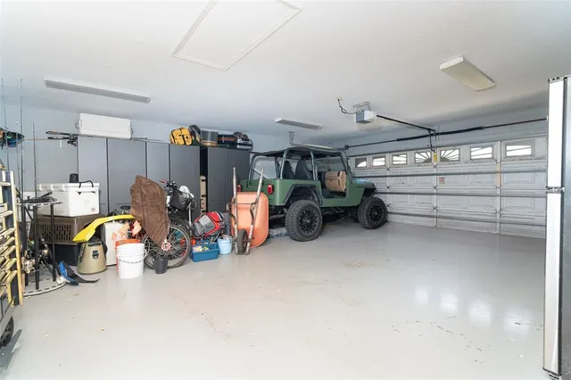 a view of a patio with table and chairs under an umbrella