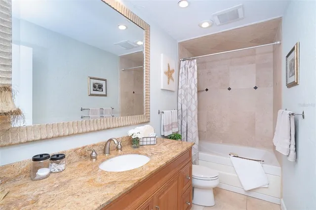 a view of a house with a small yard and potted plants