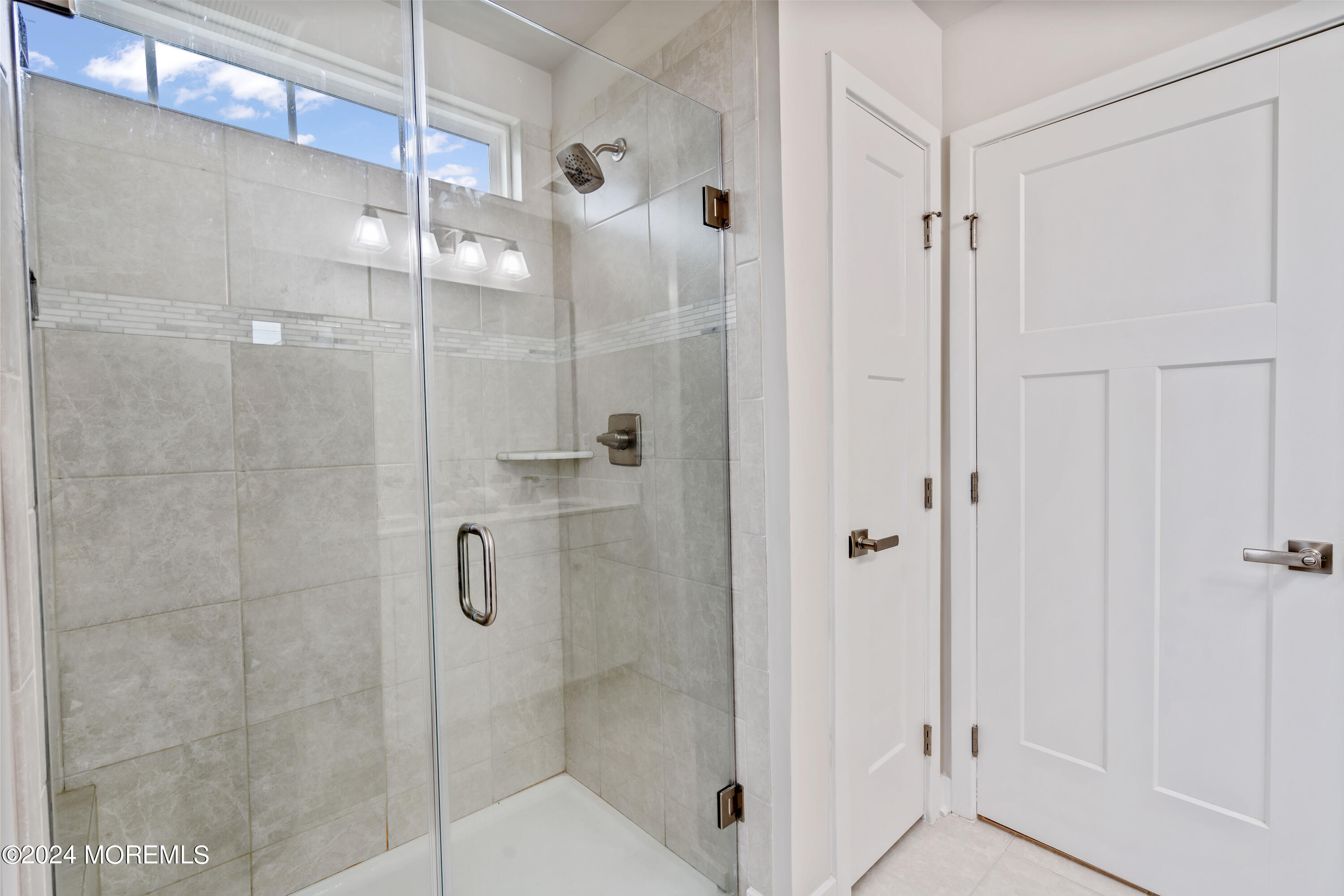83 Anchor Way Cliffwood, NJ 07721 - Photo 18 of 27 a bathroom with a glass shower door