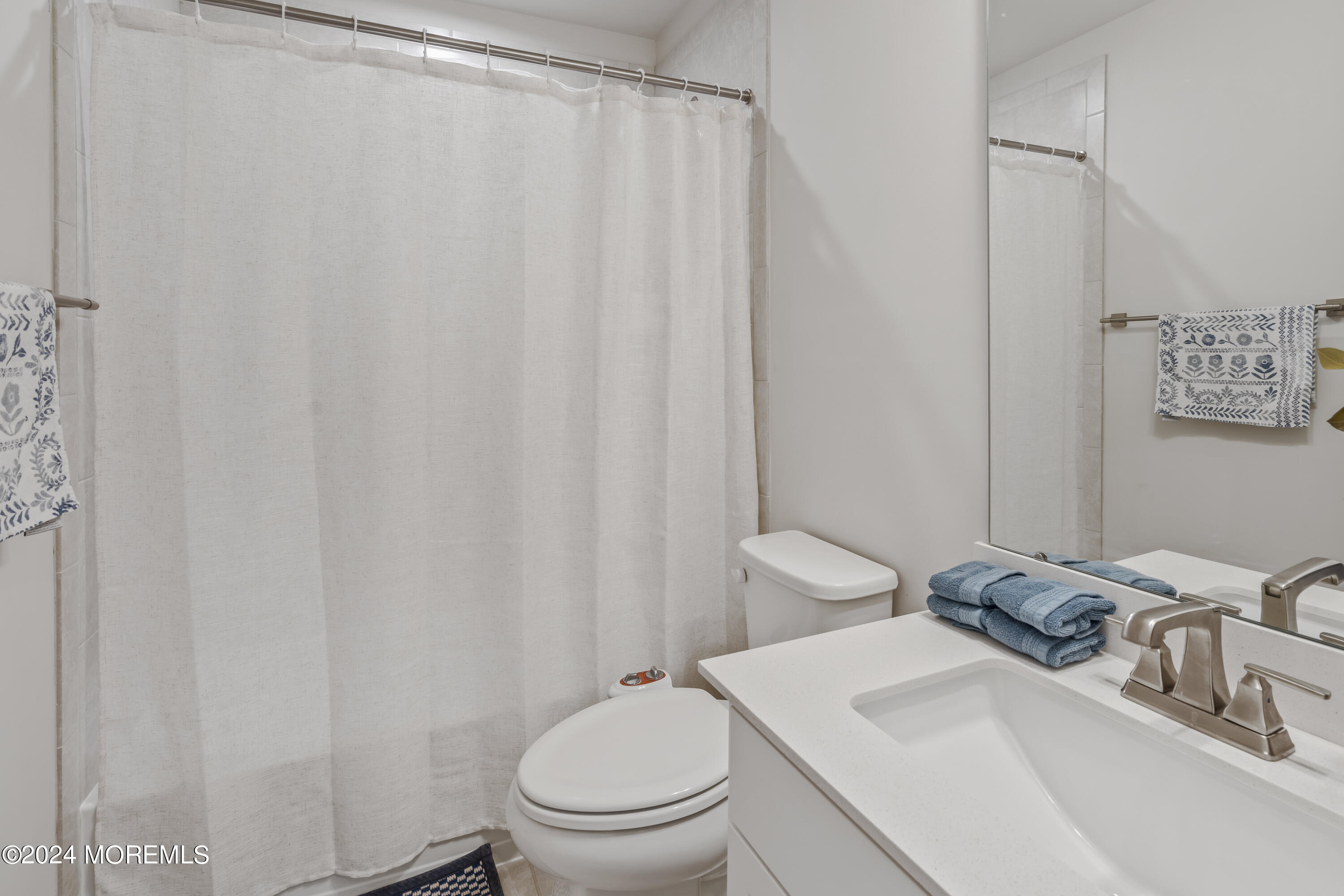 83 Anchor Way Cliffwood, NJ 07721 - Photo 26 of 27 a bathroom with a toilet a sink and curtain