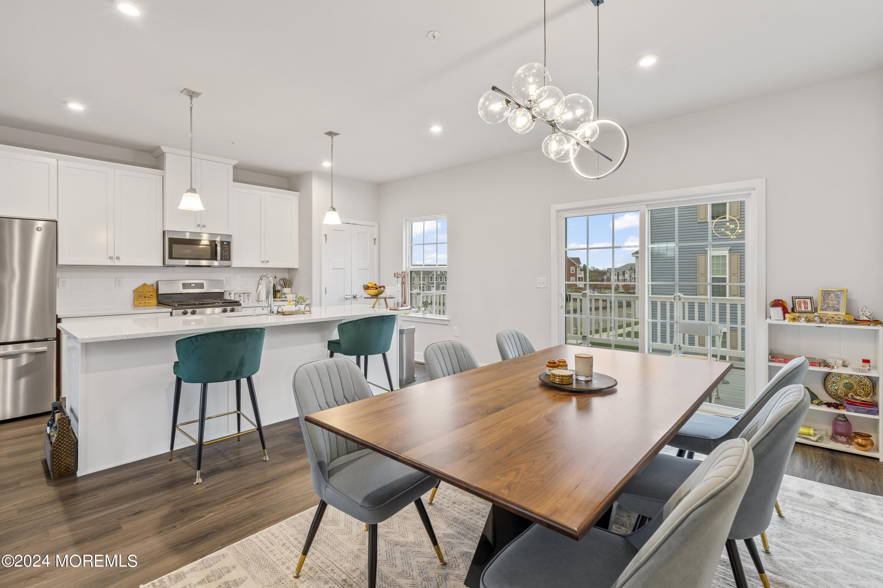 83 Anchor Way Cliffwood, NJ 07721 - Photo 7 of 27 a kitchen with kitchen island a dining table and chairs