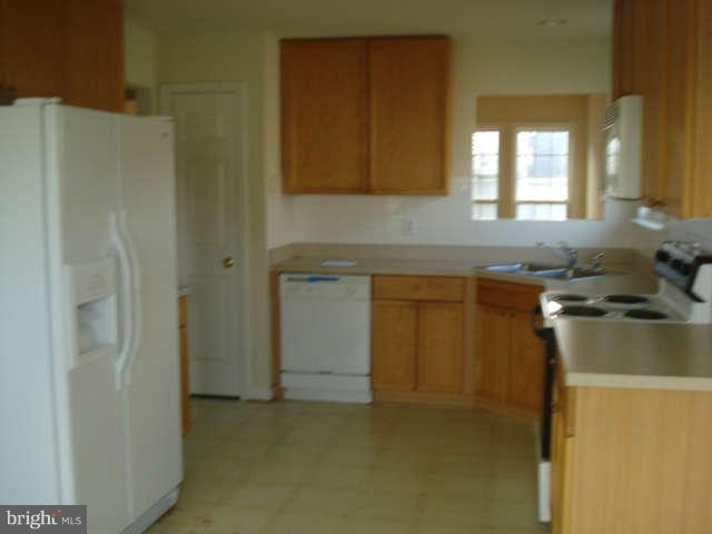 104 Limited Drive Ranson, WV 25438 - Photo 6 of 13 a kitchen with a sink and cabinets