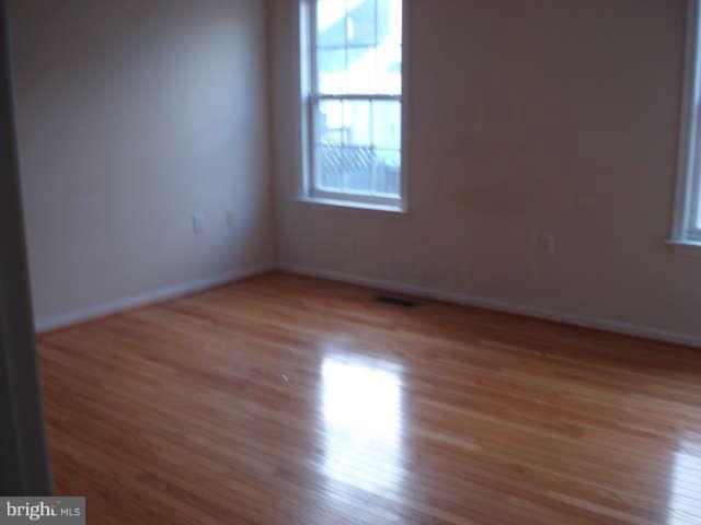 104 Limited Drive Ranson, WV 25438 - Photo 7 of 13 an empty room with wooden floor and windows