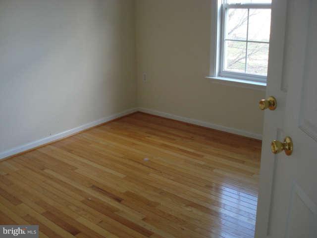 104 Limited Drive Ranson, WV 25438 - Photo 10 of 13 an empty room with wooden floor and windows