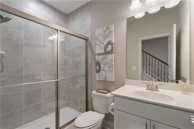 a bathroom with a sink toilet and shower