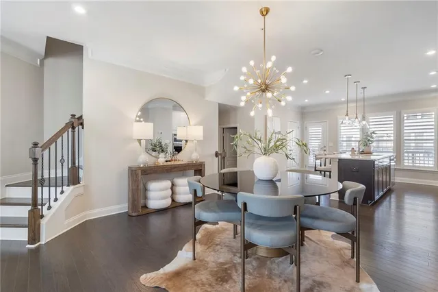 a dining room with furniture a chandelier and wooden floor