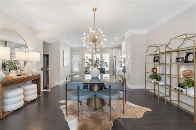 a dining room with furniture a chandelier and wooden floor