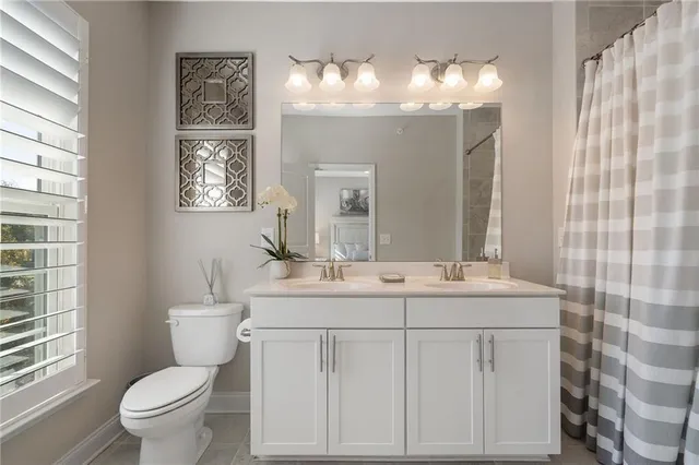a view of bathroom with a toilet sink and mirror