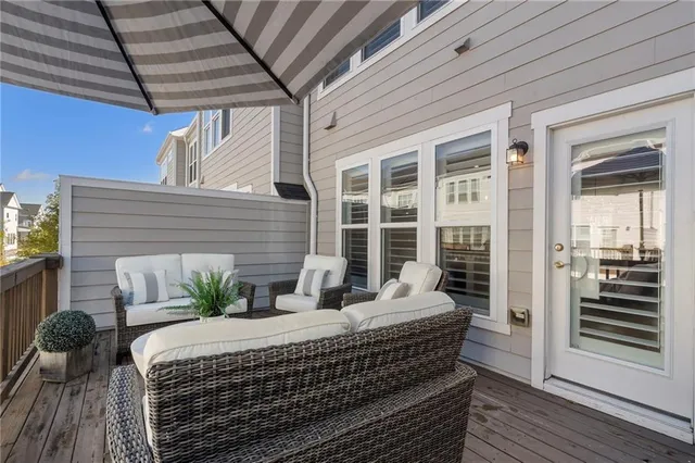 a balcony with furniture and wooden floor