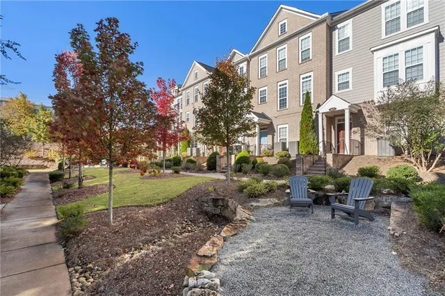 a view of a building with a yard and sitting area