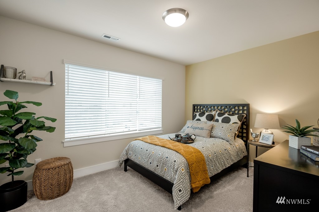 620 215th Street Southeast, Unit RM6 Bothell, WA 98021 - Photo 14 of 28 a bedroom with bed plant and window