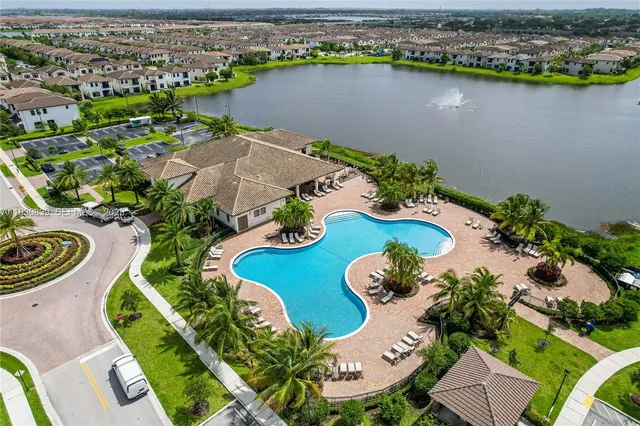 an aerial view of a house with swimming pool and outdoor space