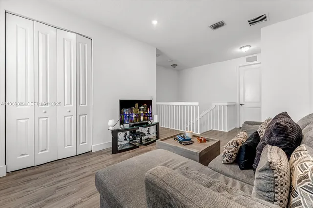 a bedroom with a bed and a television