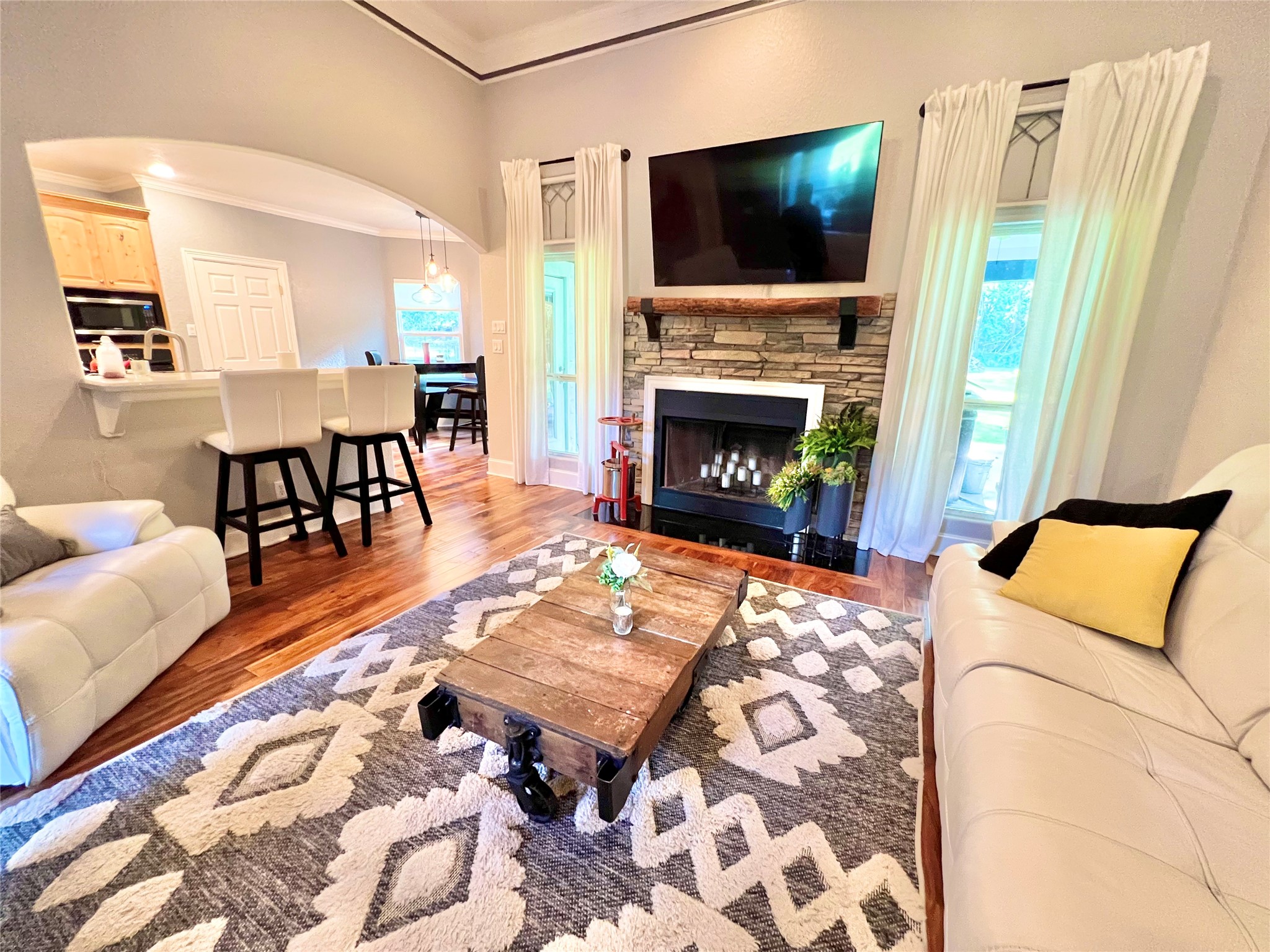 6714 Jay Road Hitchcock, TX 77563 - Photo 12 of 50 a living room with furniture a flat screen tv and a fireplace