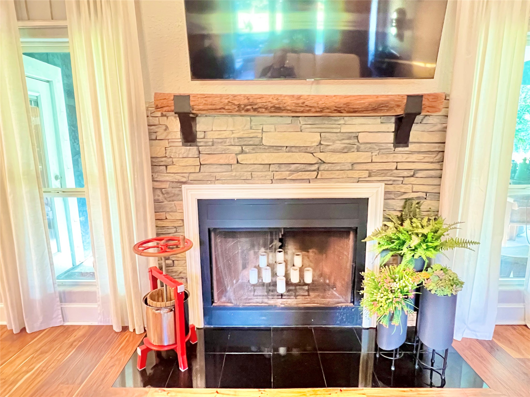 6714 Jay Road Hitchcock, TX 77563 - Photo 13 of 50 a living room with a fireplace and potted plants