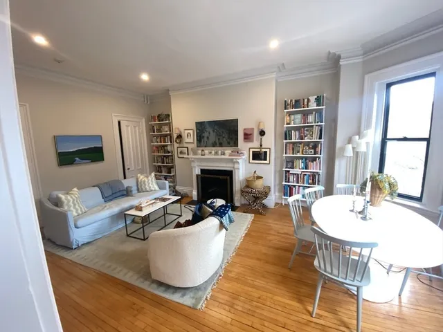 a living room with fireplace furniture and a flat screen tv