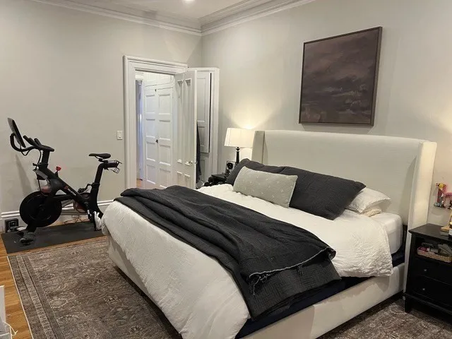 a bedroom with a bed and a dresser